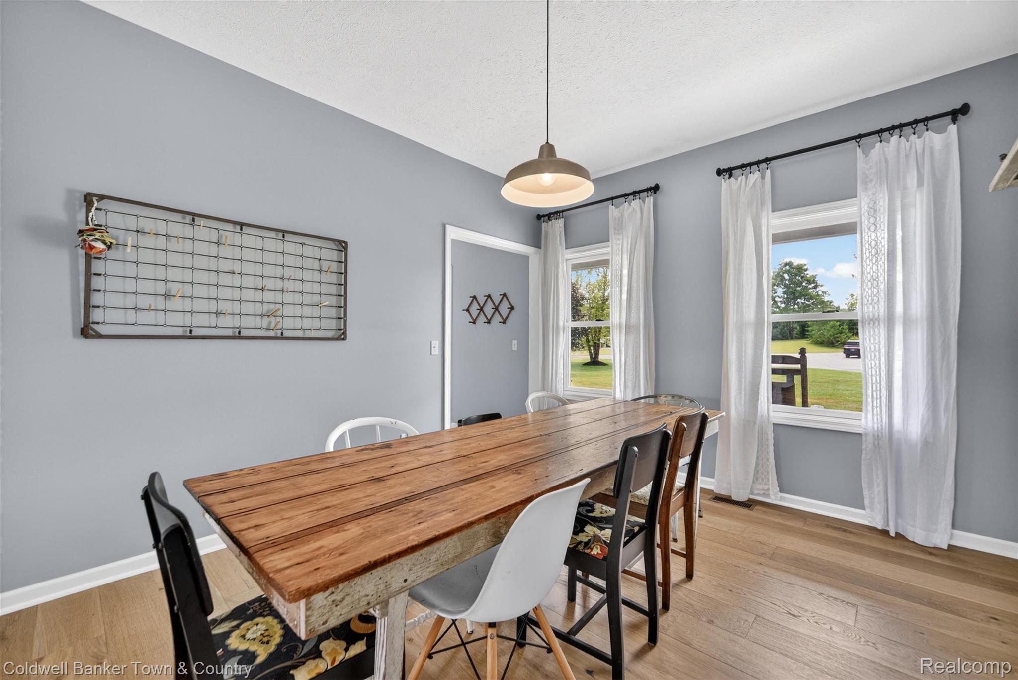 918 Gray Fox Court Howell, MI 48843 - Photo 19 of 84 Dining area featuring wood-finish flooring, light gray wall color, and white trim