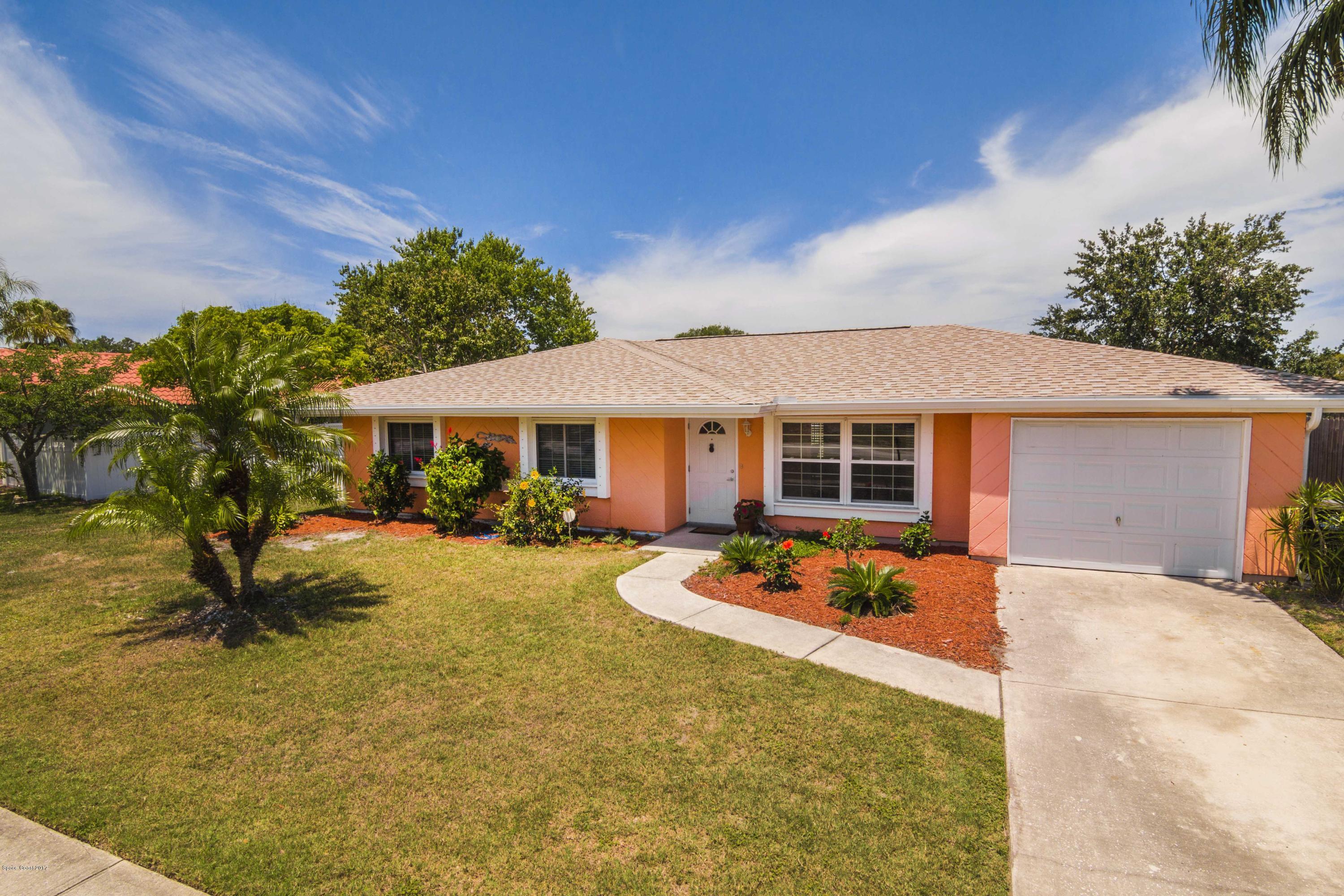 905 Riviera Drive Northeast Palm Bay, FL 32905 - Photo 1 of 21 a front view of a house with patio