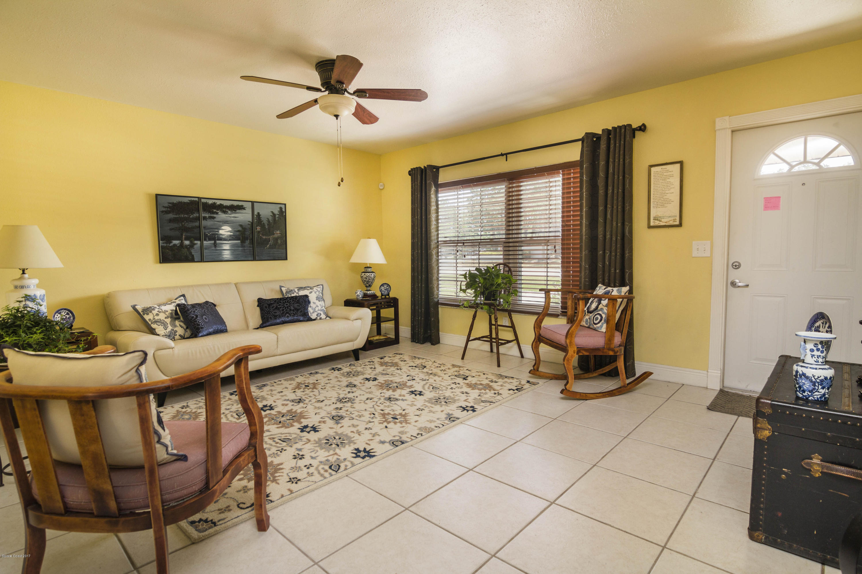 905 Riviera Drive Northeast Palm Bay, FL 32905 - Photo 2 of 21 a living room with furniture and a flat screen tv
