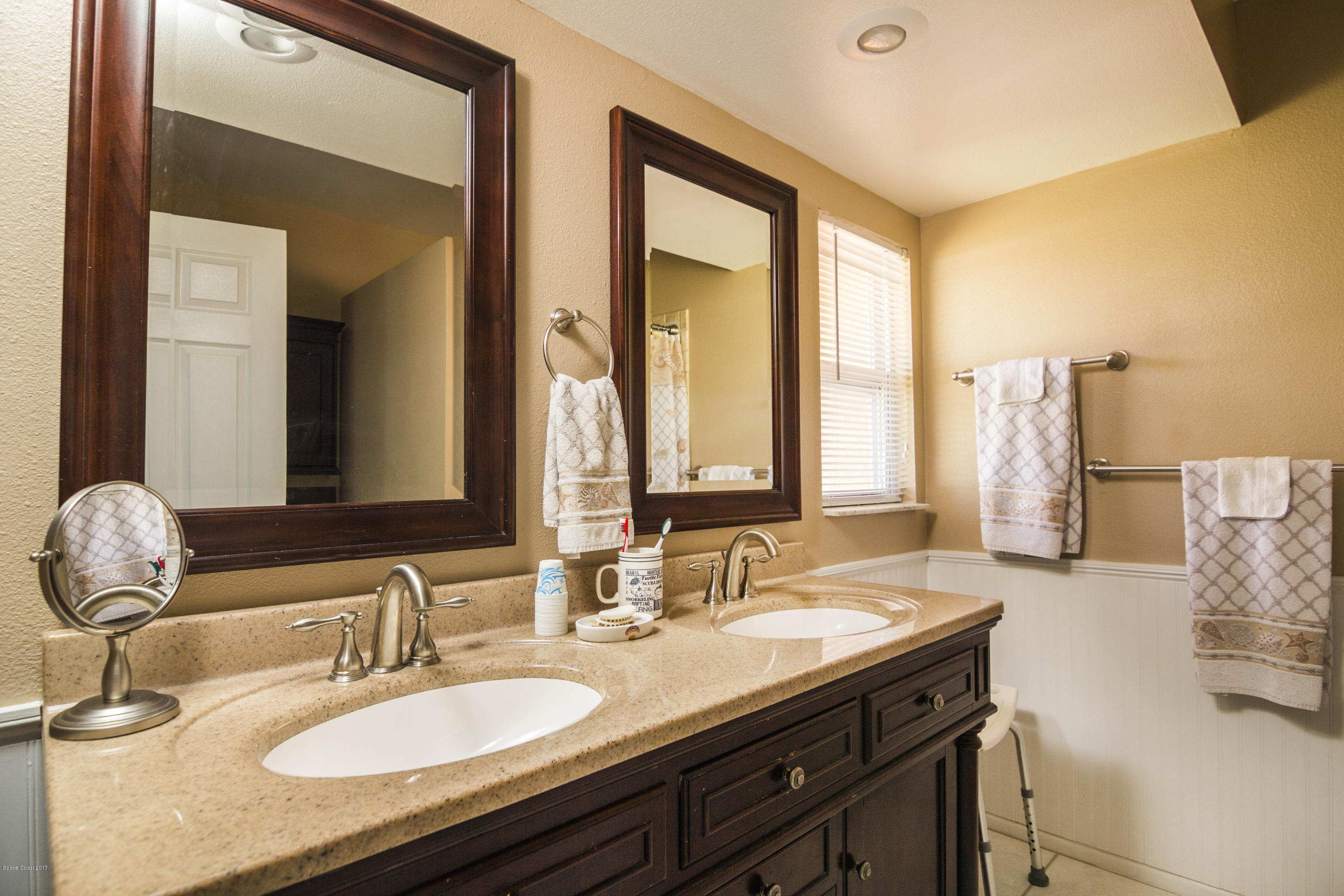 905 Riviera Drive Northeast Palm Bay, FL 32905 - Photo 11 of 21 a bathroom with a granite countertop sink and a mirror