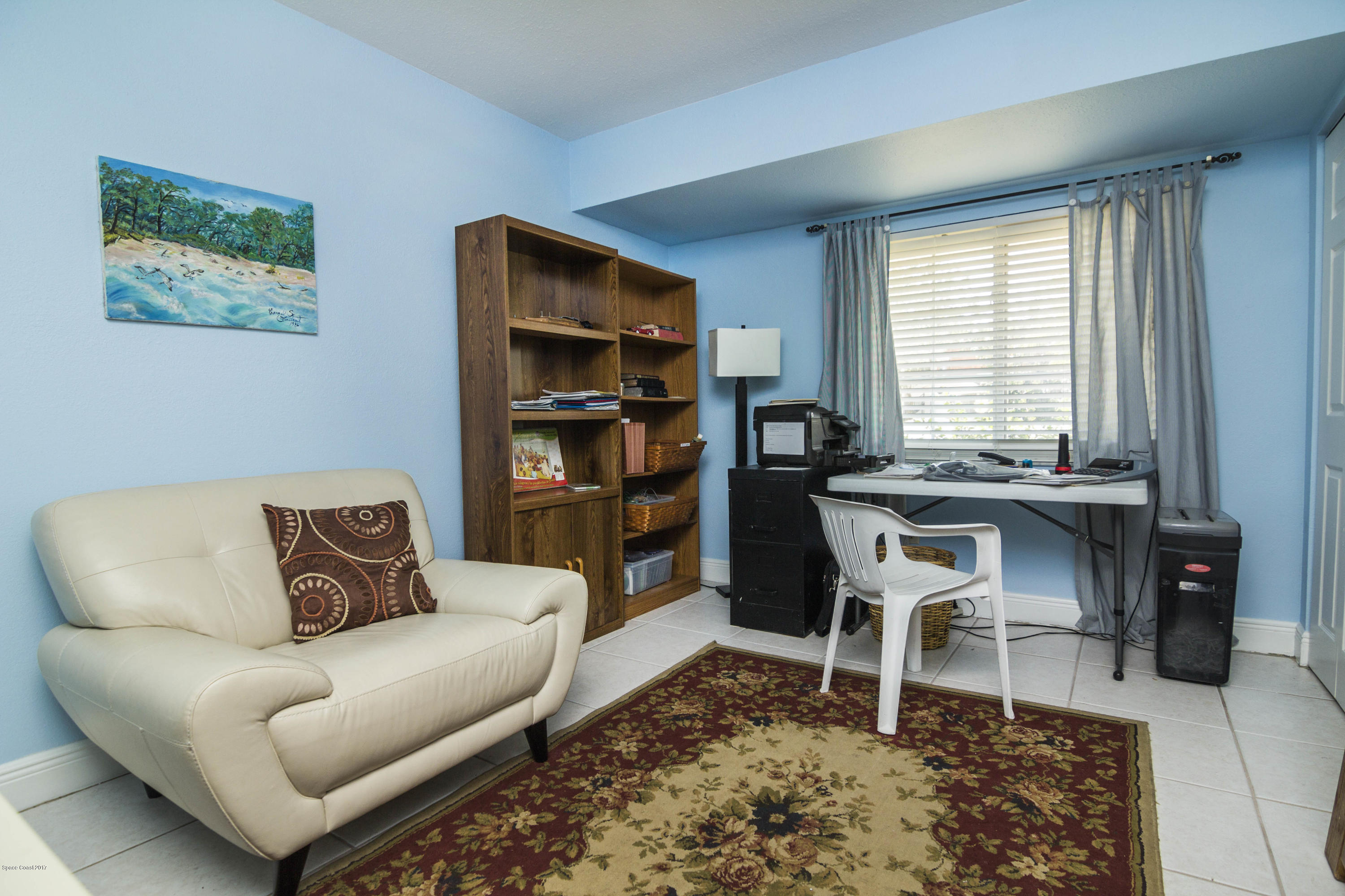 905 Riviera Drive Northeast Palm Bay, FL 32905 - Photo 13 of 21 a living room with furniture a rug and a window