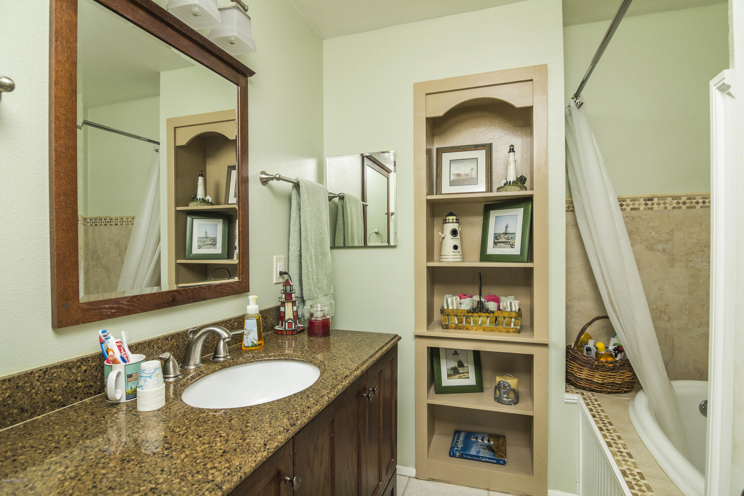 905 Riviera Drive Northeast Palm Bay, FL 32905 - Photo 14 of 21 a bathroom with a sink a vanity and a mirror