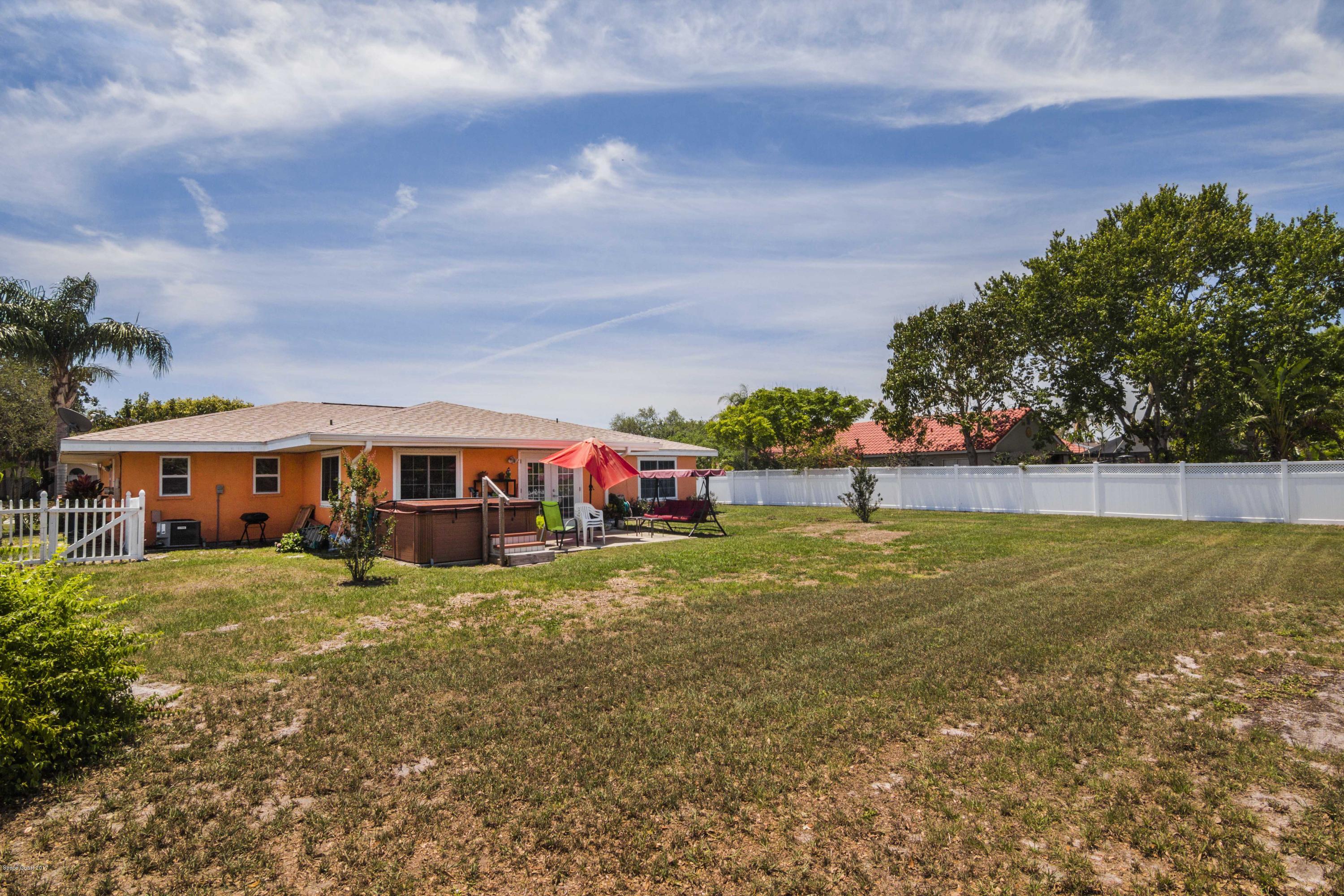 905 Riviera Drive Northeast Palm Bay, FL 32905 - Photo 16 of 21 a view of a house with a yard