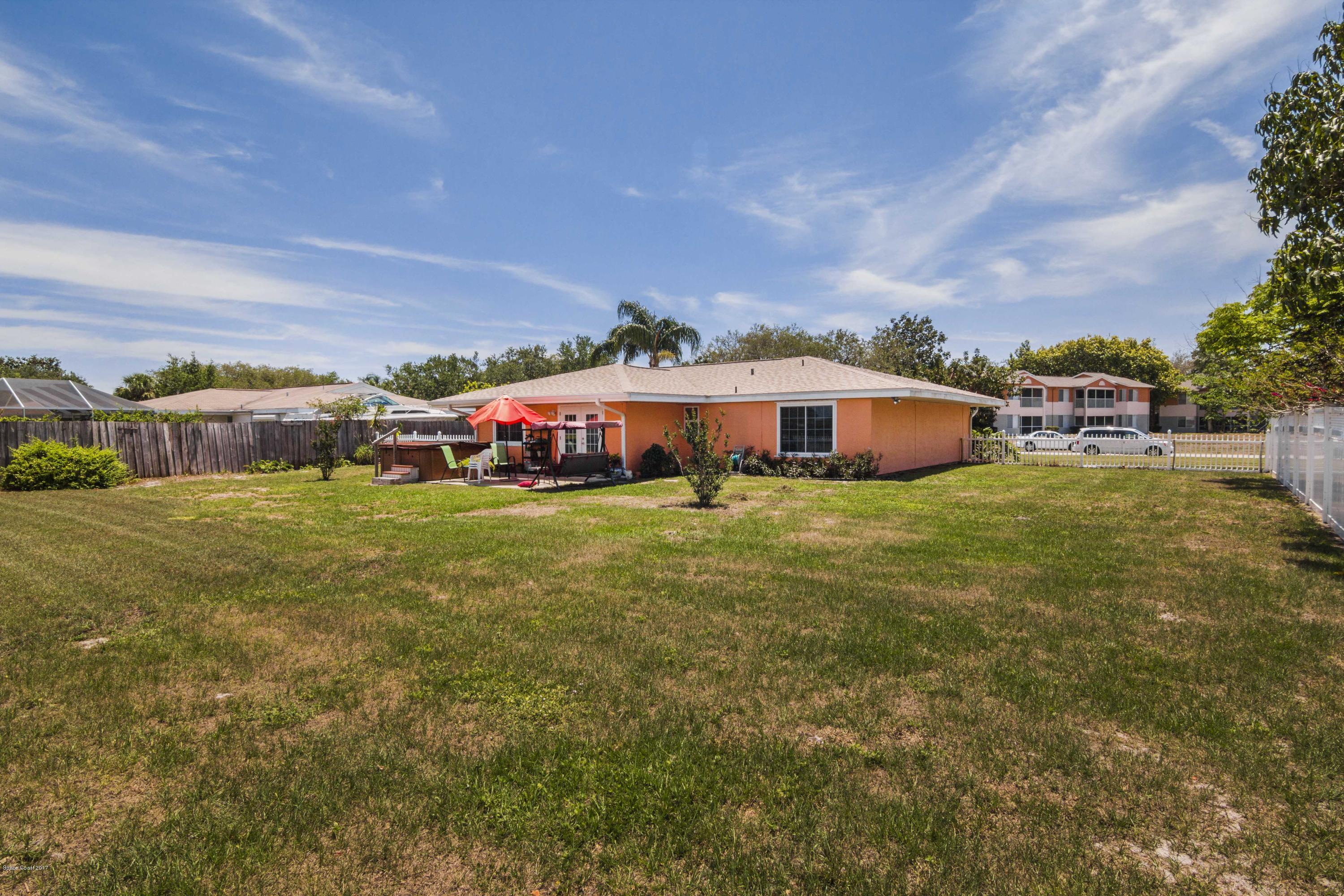 905 Riviera Drive Northeast Palm Bay, FL 32905 - Photo 17 of 21 a view of a house with a yard and sitting area