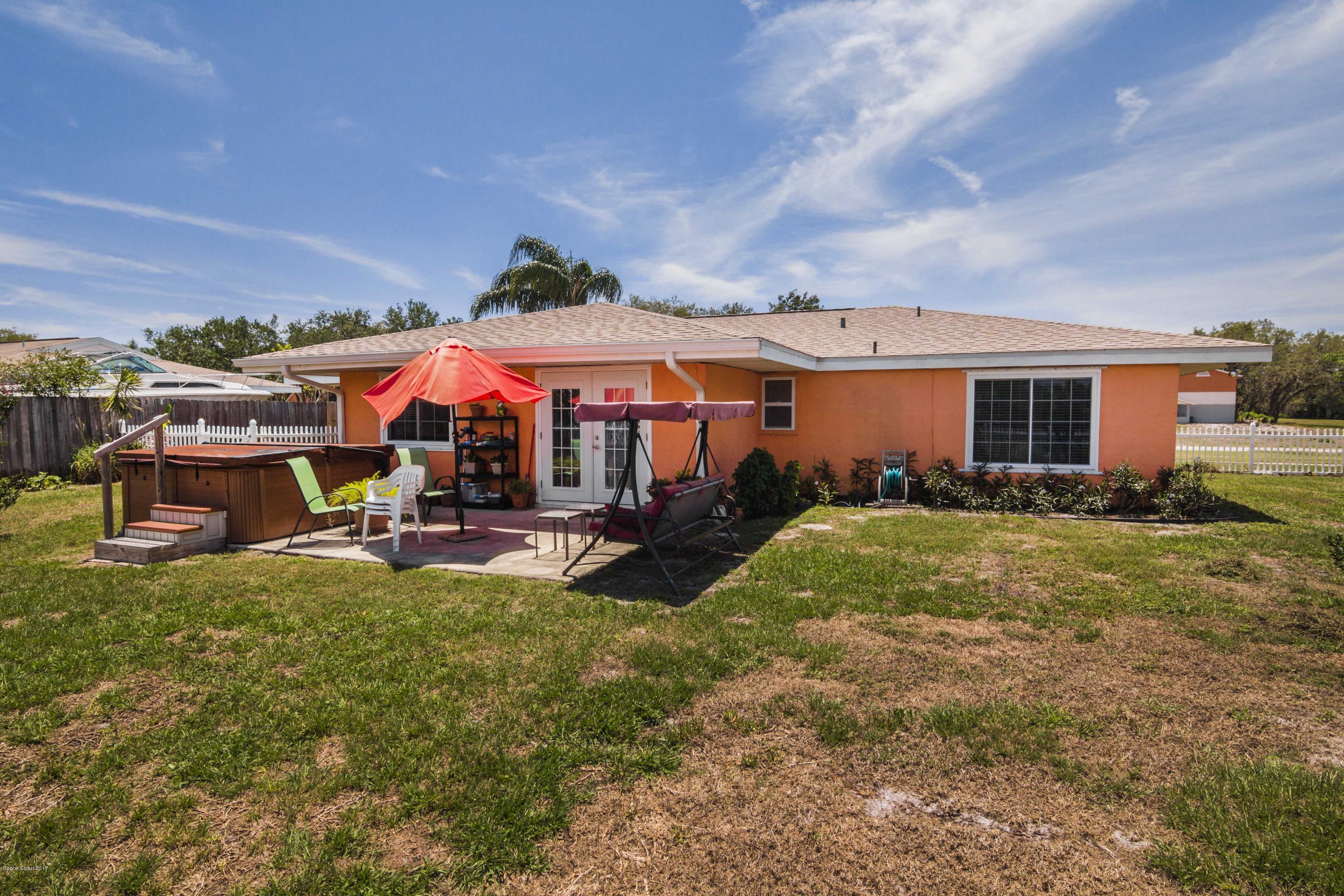 905 Riviera Drive Northeast Palm Bay, FL 32905 - Photo 18 of 21 a view of a house with backyard porch and sitting area