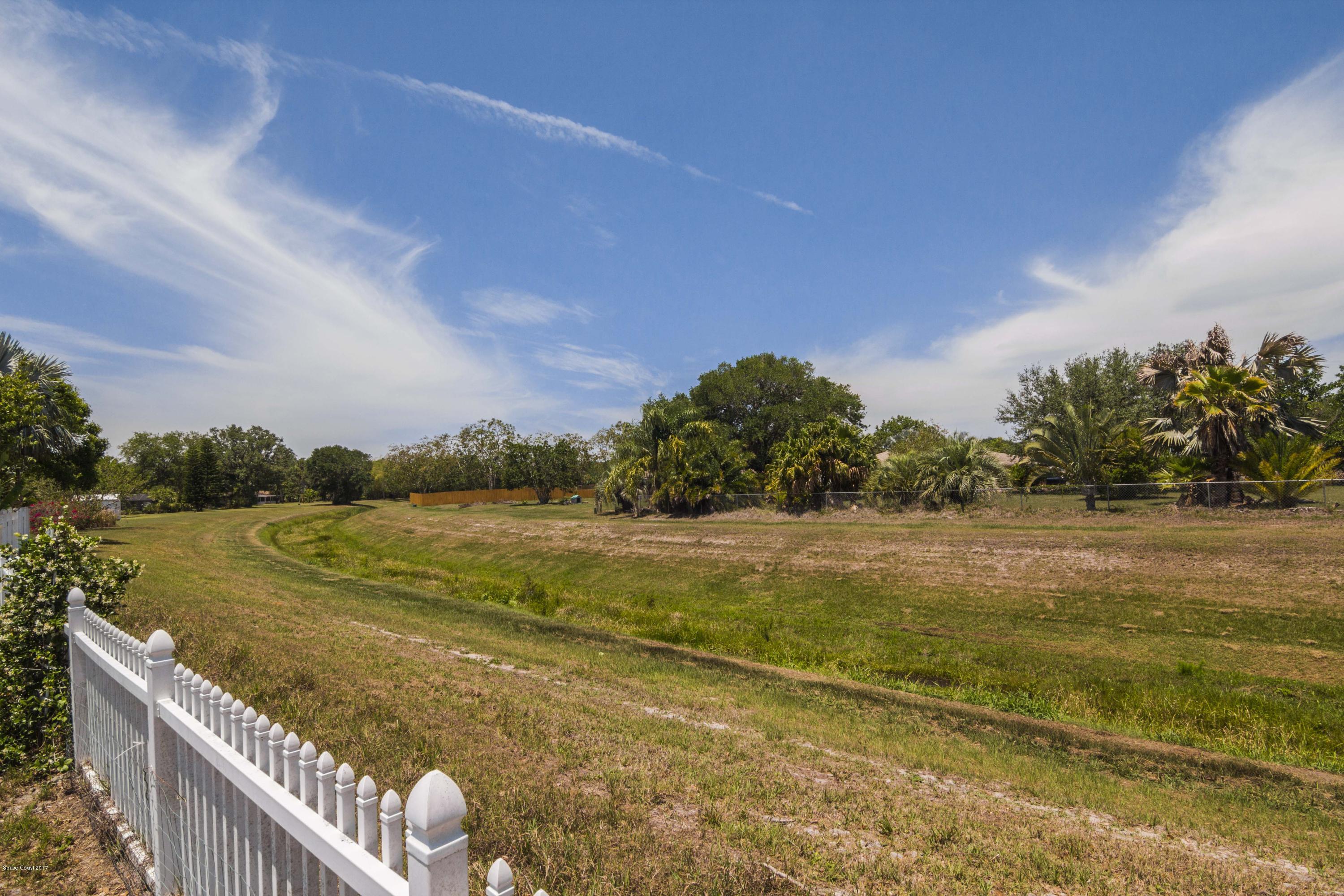 905 Riviera Drive Northeast Palm Bay, FL 32905 - Photo 20 of 21 a view of a lake with a yard