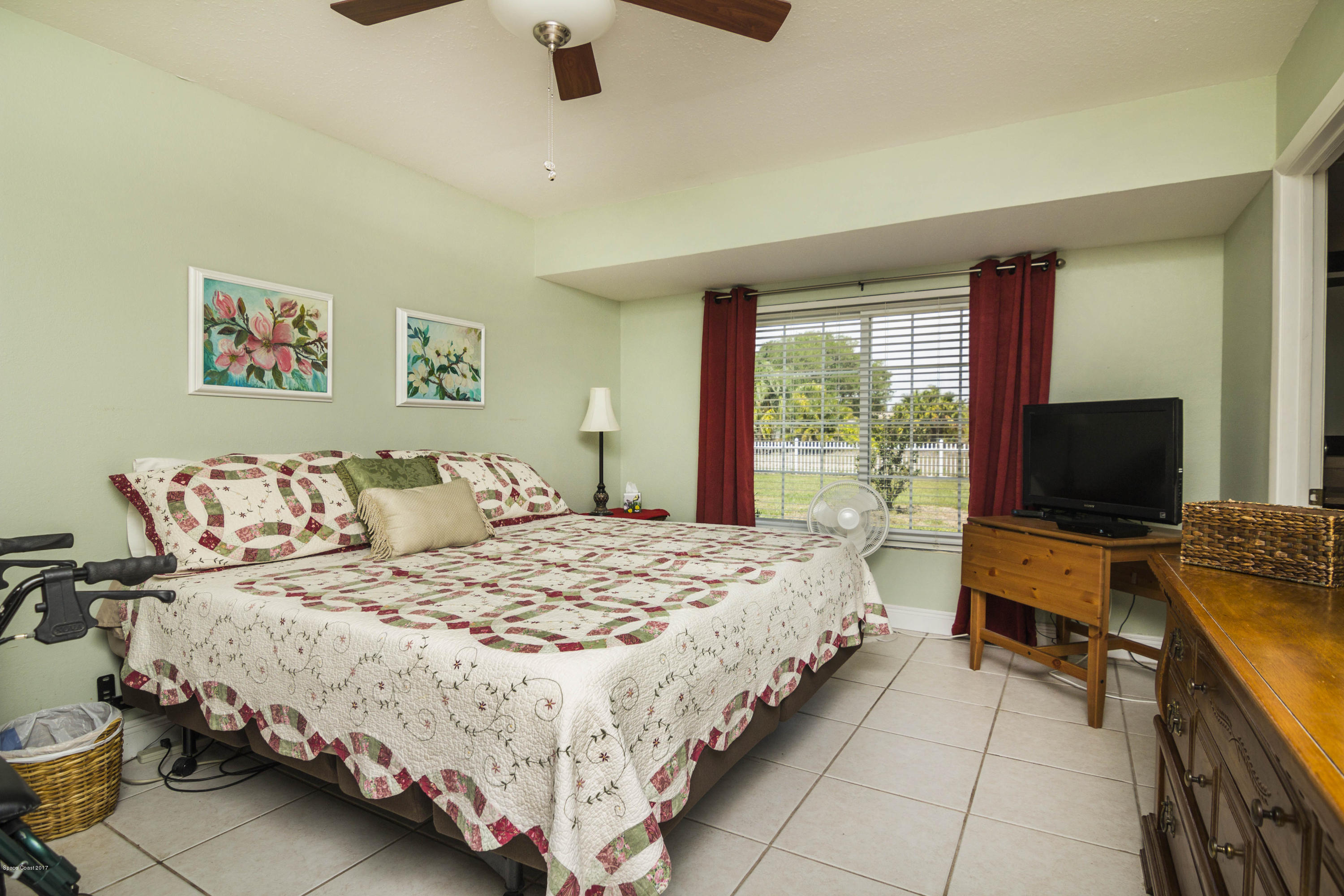 905 Riviera Drive Northeast Palm Bay, FL 32905 - Photo 10 of 21 a bedroom with a bed and a flat screen tv
