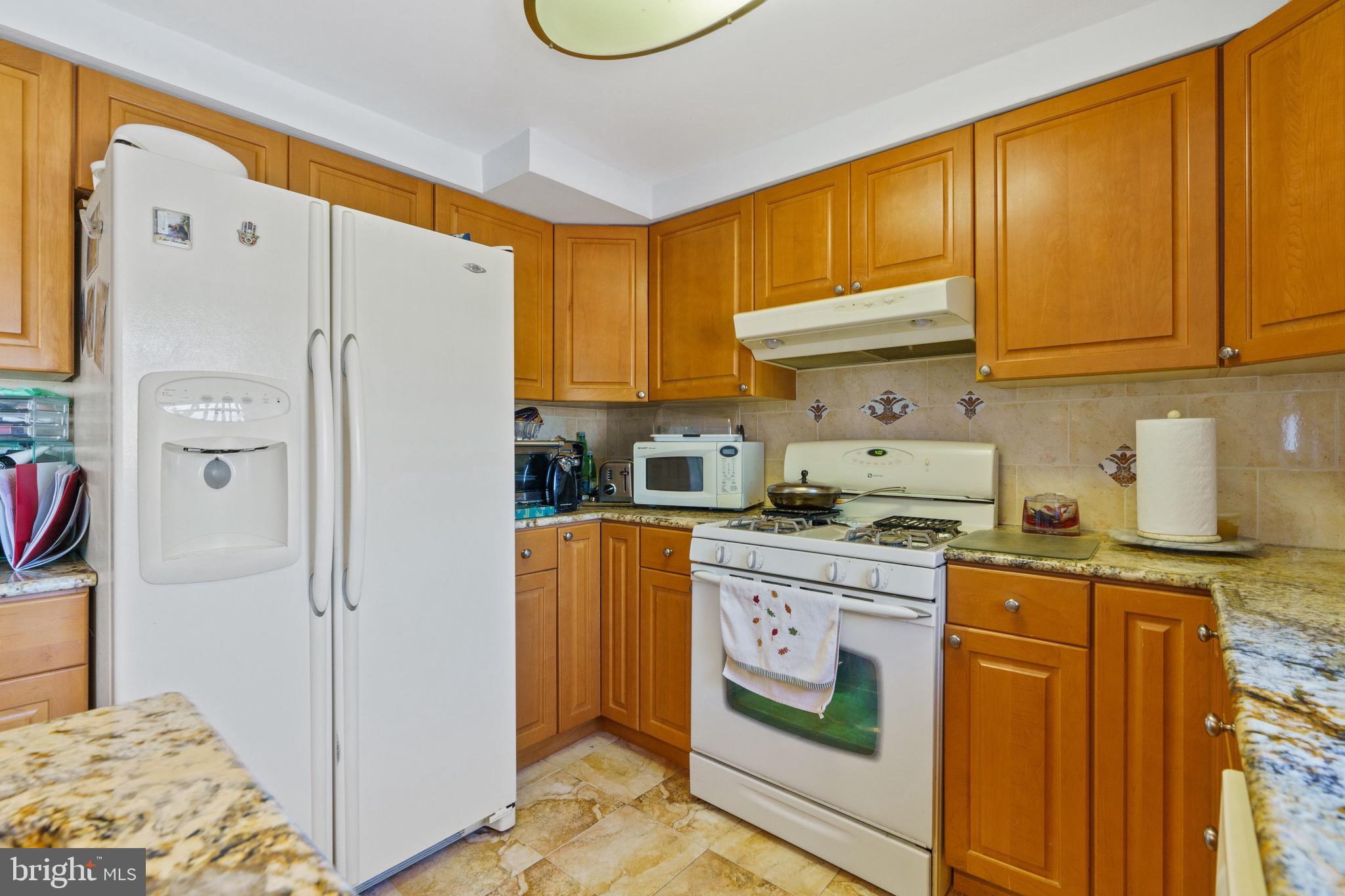 1122 Surrey Road Philadelphia, PA 19115 - Photo 14 of 29 a kitchen with stainless steel appliances granite countertop a stove a refrigerator and a refrigerator