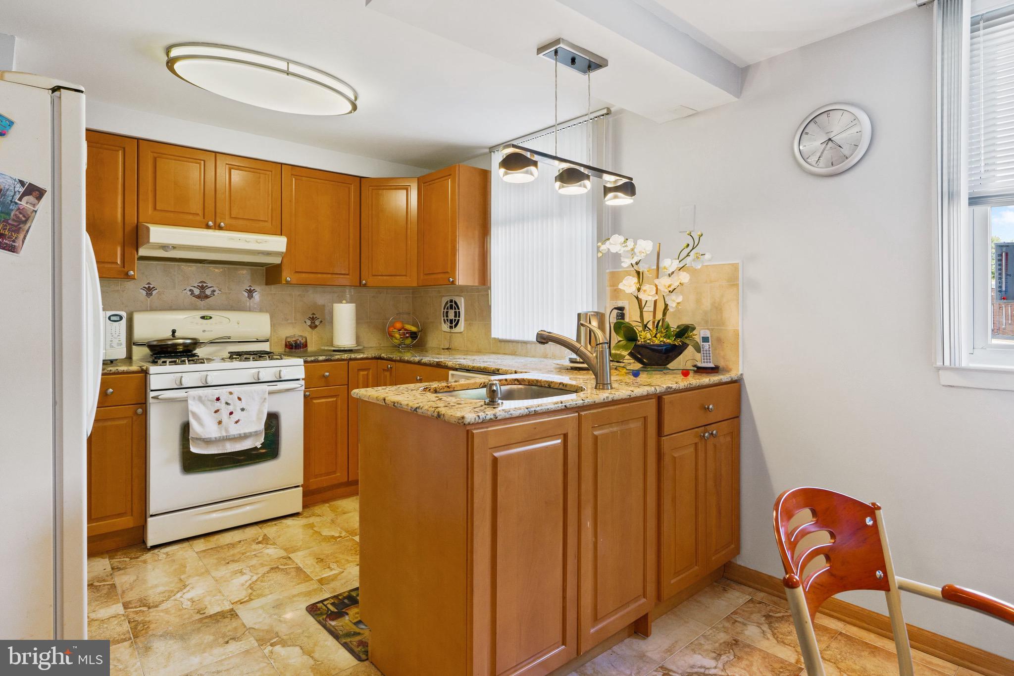 1122 Surrey Road Philadelphia, PA 19115 - Photo 15 of 29 a kitchen with stainless steel appliances granite countertop a stove a sink and a refrigerator