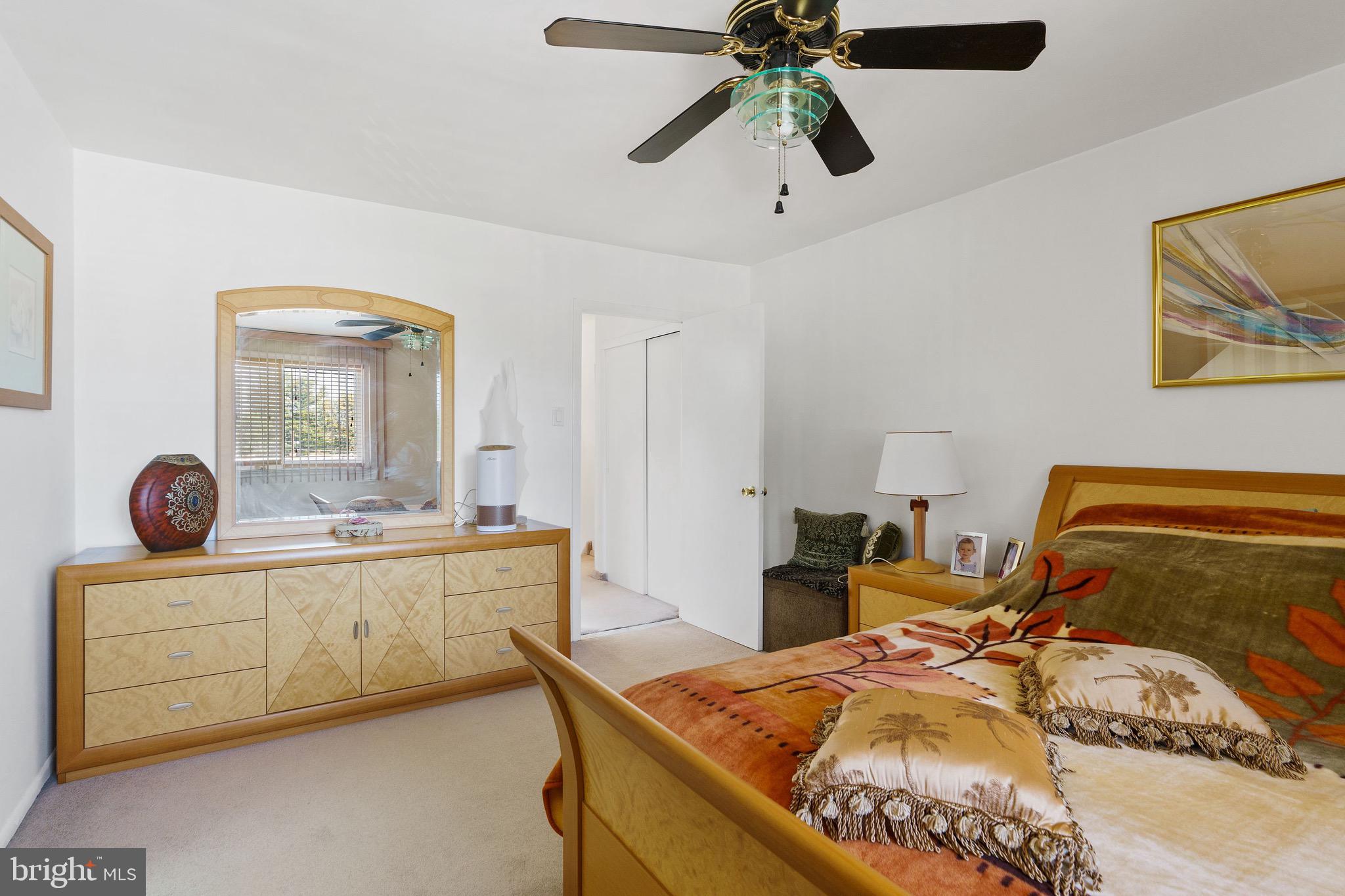 1122 Surrey Road Philadelphia, PA 19115 - Photo 18 of 29 a bedroom with furniture and a chandelier