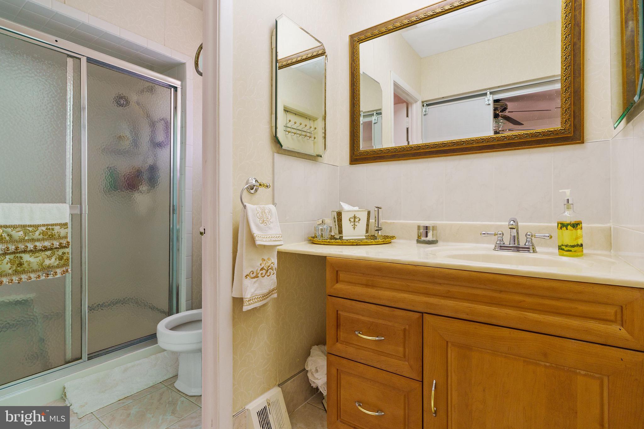 1122 Surrey Road Philadelphia, PA 19115 - Photo 19 of 29 a bathroom with a sink a toilet and shower