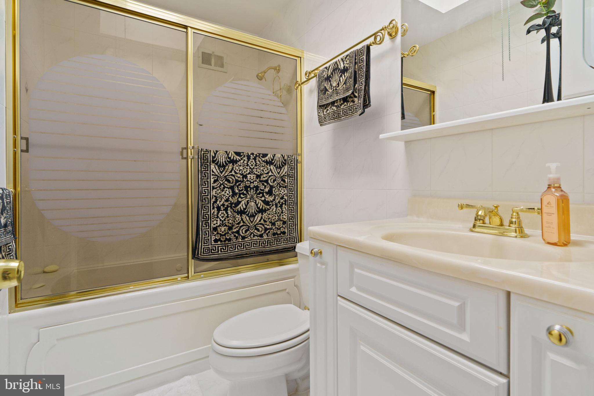 1122 Surrey Road Philadelphia, PA 19115 - Photo 20 of 29 a bathroom with a granite countertop sink a toilet and shower