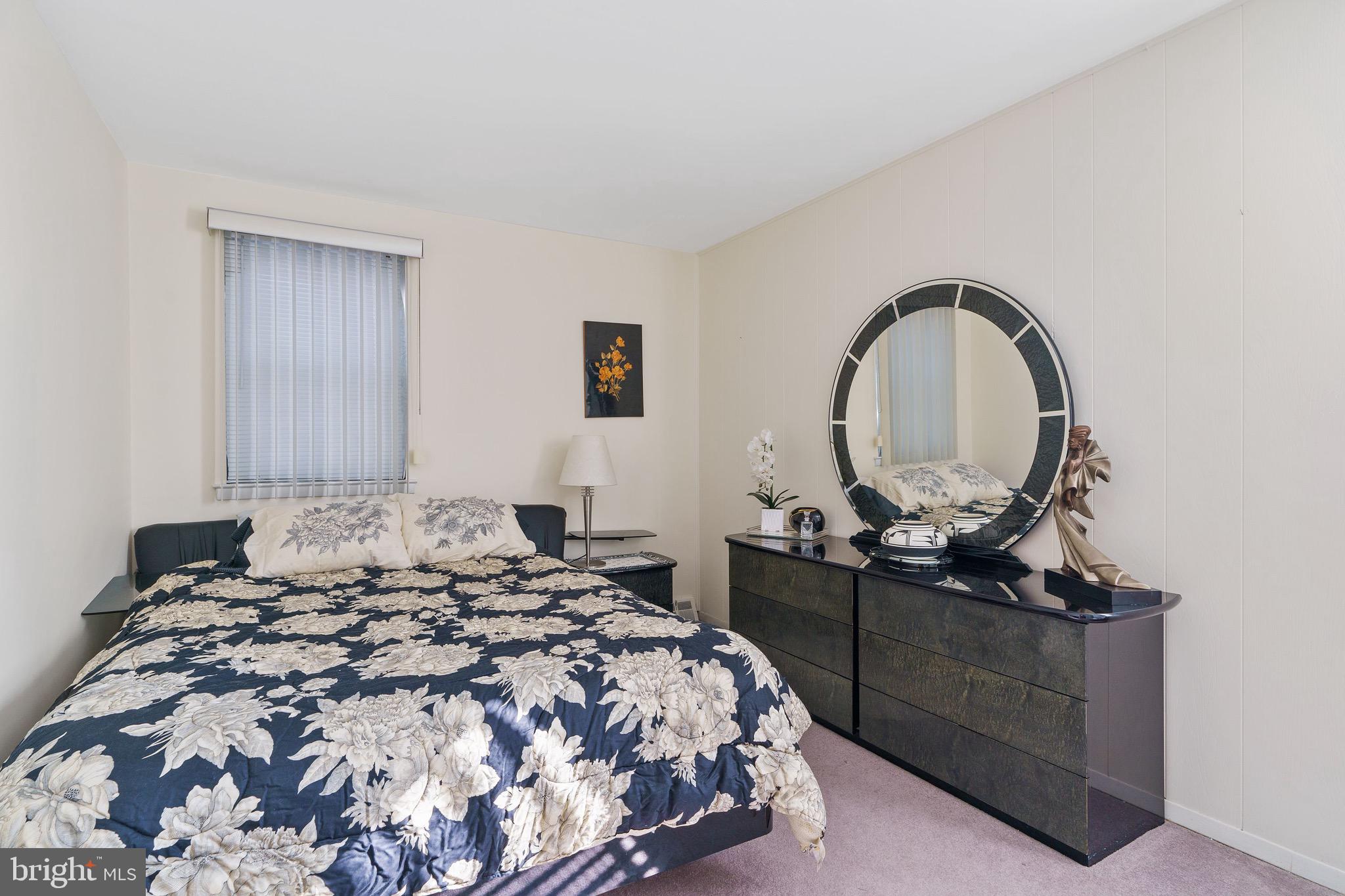 1122 Surrey Road Philadelphia, PA 19115 - Photo 21 of 29 a bedroom with a bed and a dresser