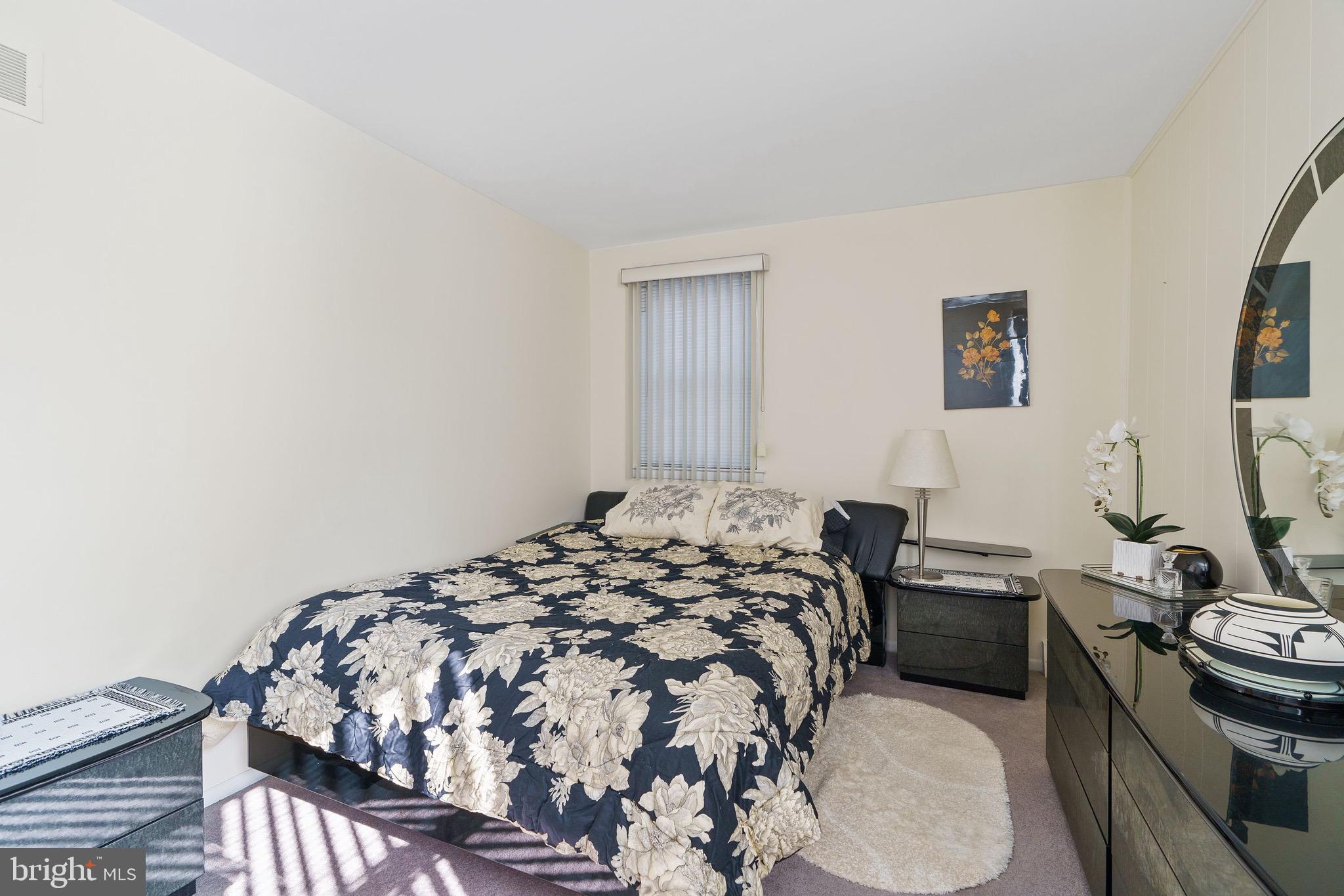 1122 Surrey Road Philadelphia, PA 19115 - Photo 22 of 29 a bedroom with a bed and a chair