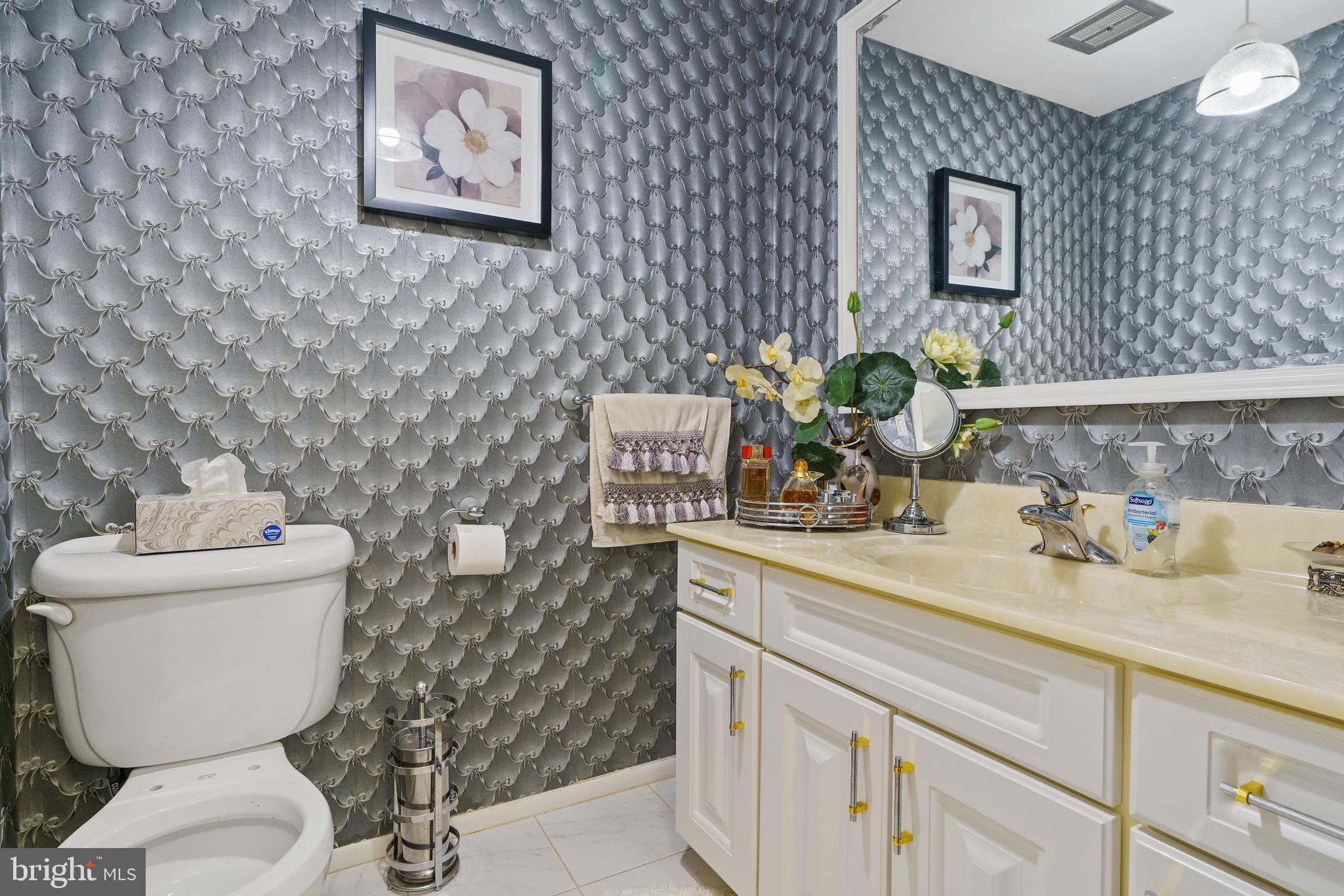 1122 Surrey Road Philadelphia, PA 19115 - Photo 25 of 29 a bathroom with a toilet sink and mirror