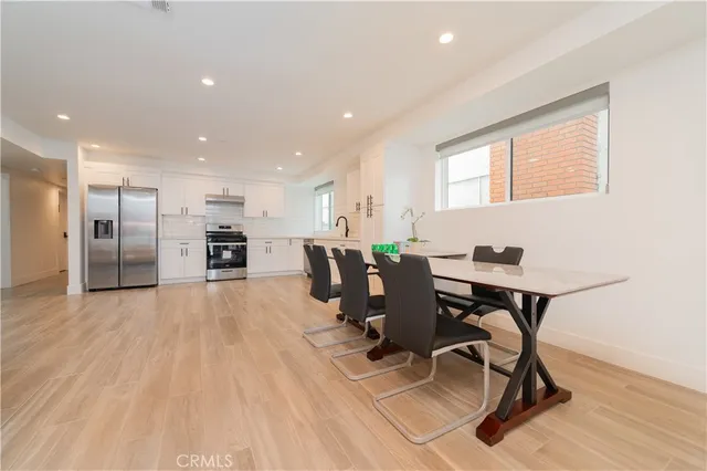 a view of a kitchen with dining room and wooden floor