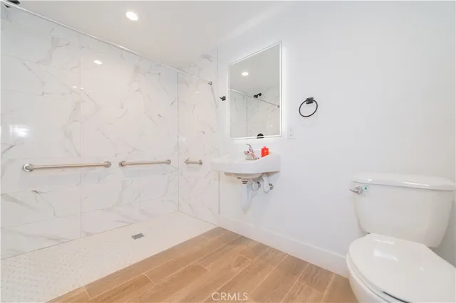 a bathroom with a toilet and a shower