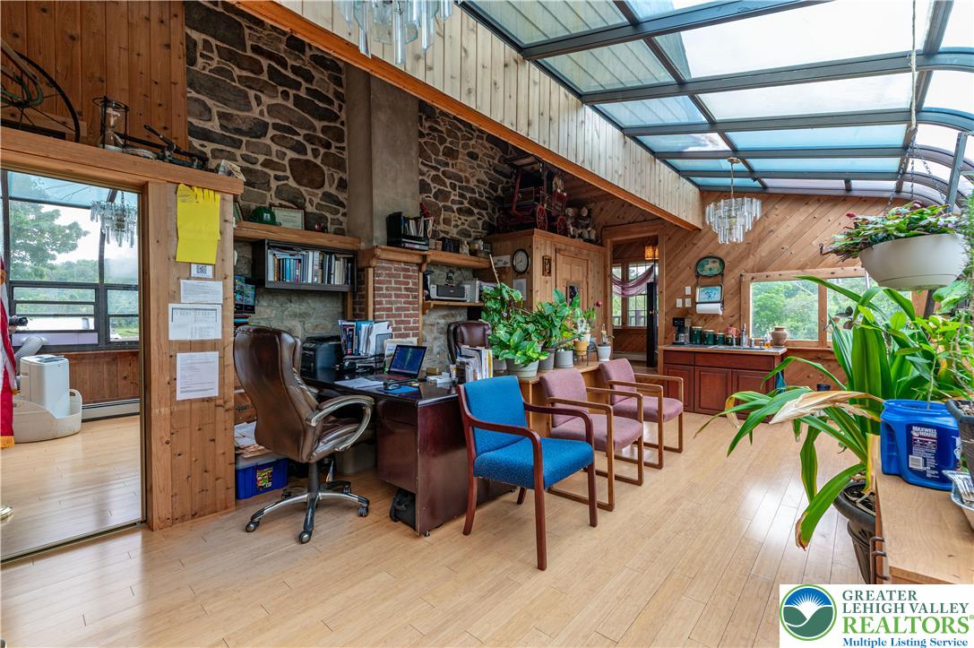 2485 Hieter Road Quakertown, PA 18951 - Photo 5 of 97 An airy office space offers a wood-paneled ceiling and stone accent walls, perfect for focused productivity.