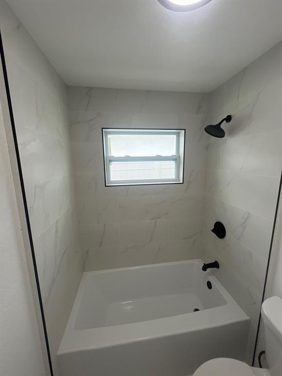 1457 West 31st Street, Unit 2 Riviera Beach, FL 33404 - Photo 11 of 16 a bathroom with a bathtub
