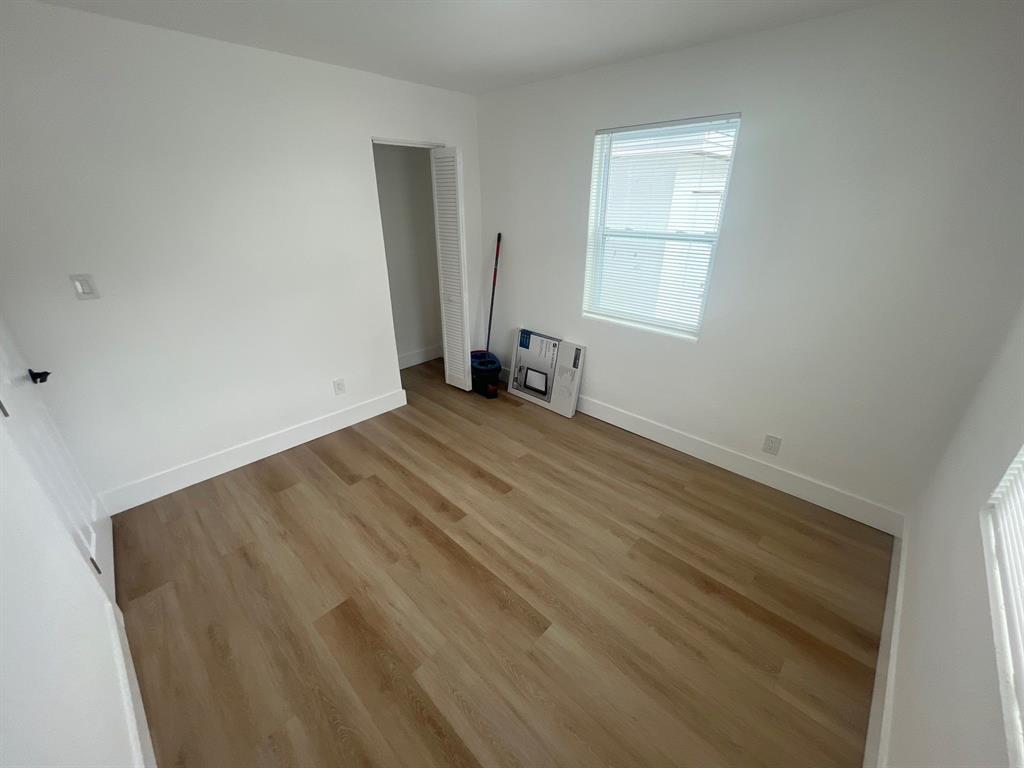 1457 West 31st Street, Unit 2 Riviera Beach, FL 33404 - Photo 14 of 16 an empty room with windows