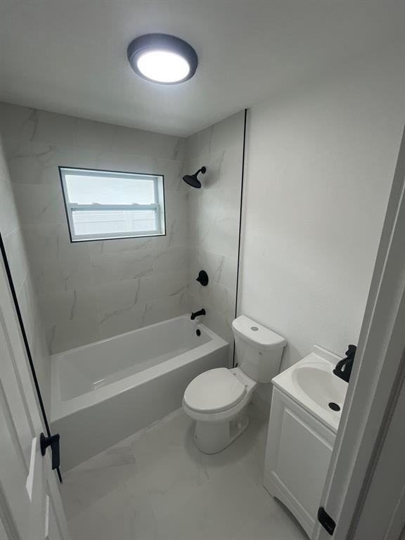 1457 West 31st Street, Unit 2 Riviera Beach, FL 33404 - Photo 10 of 16 a bathroom with a toilet a sink and a bathtub