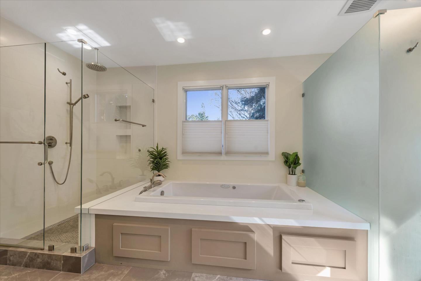 455 San Mateo Drive Menlo Park, CA 94025 - Photo 15 of 37 a bathroom with a sink a vanity a mirror and a shower