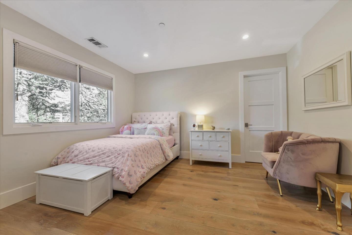 455 San Mateo Drive Menlo Park, CA 94025 - Photo 18 of 37 a bedroom with a bed and a chair