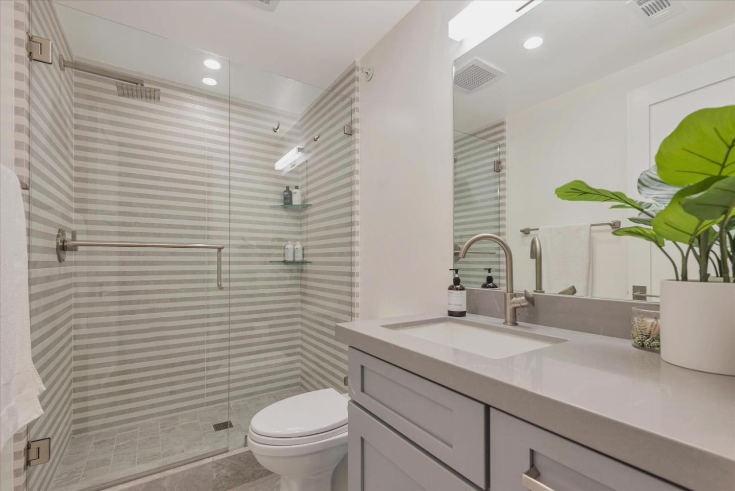 455 San Mateo Drive Menlo Park, CA 94025 - Photo 28 of 37 a bathroom with a granite countertop sink a toilet and mirror