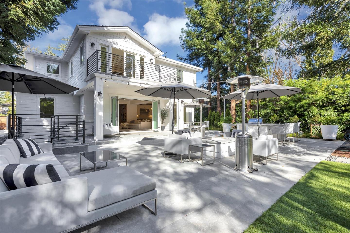 455 San Mateo Drive Menlo Park, CA 94025 - Photo 29 of 37 a view of a patio with couches table and chairs under an umbrella with a barbeque