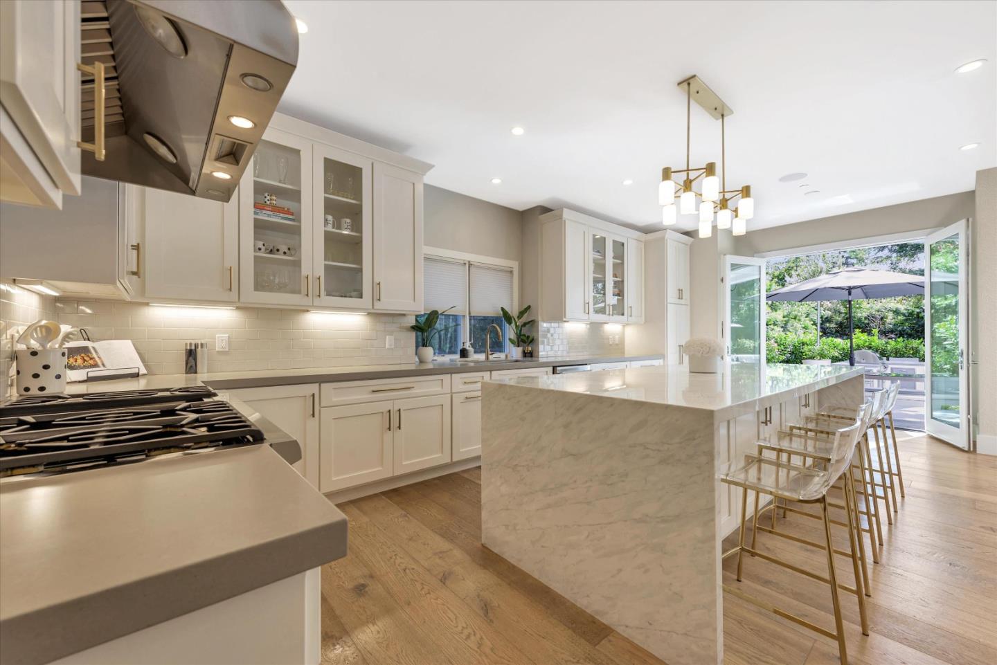 455 San Mateo Drive Menlo Park, CA 94025 - Photo 8 of 37 a kitchen with kitchen island stainless steel appliances a sink stove and cabinets
