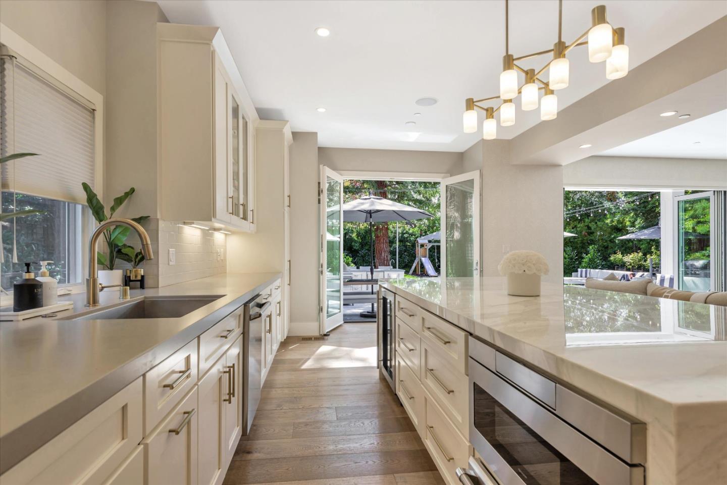 455 San Mateo Drive Menlo Park, CA 94025 - Photo 9 of 37 a large kitchen with kitchen island lots of counter space a sink appliances and a large window