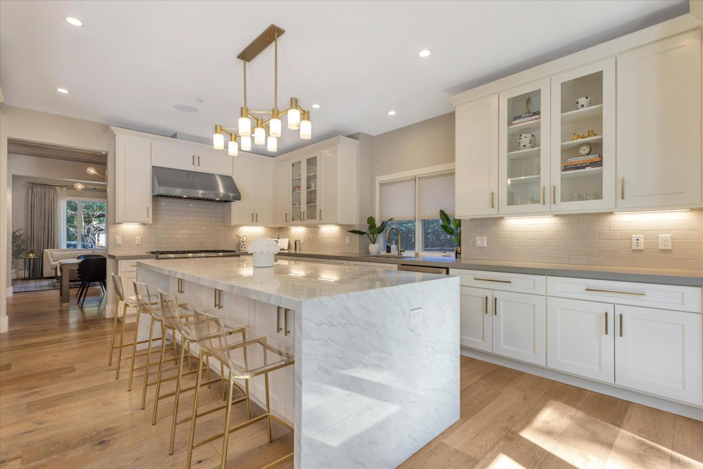 455 San Mateo Drive Menlo Park, CA 94025 - Photo 10 of 37 a kitchen with granite countertop a stove a sink a dining table and chairs