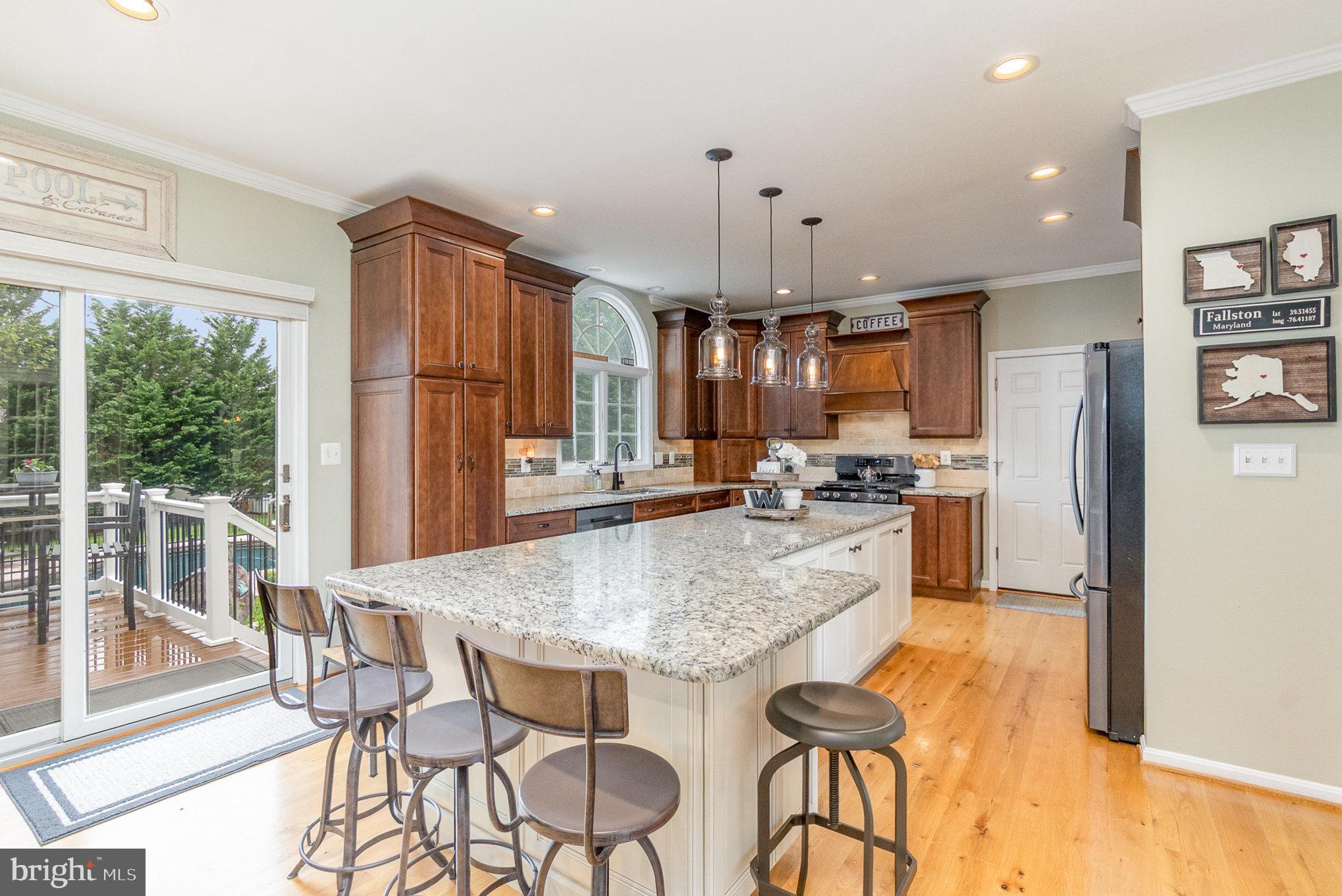 523 Copeland Road Fallston, MD 21047 - Photo 25 of 72 a kitchen with stainless steel appliances granite countertop a refrigerator a oven a sink a dining table and chairs with wooden floor