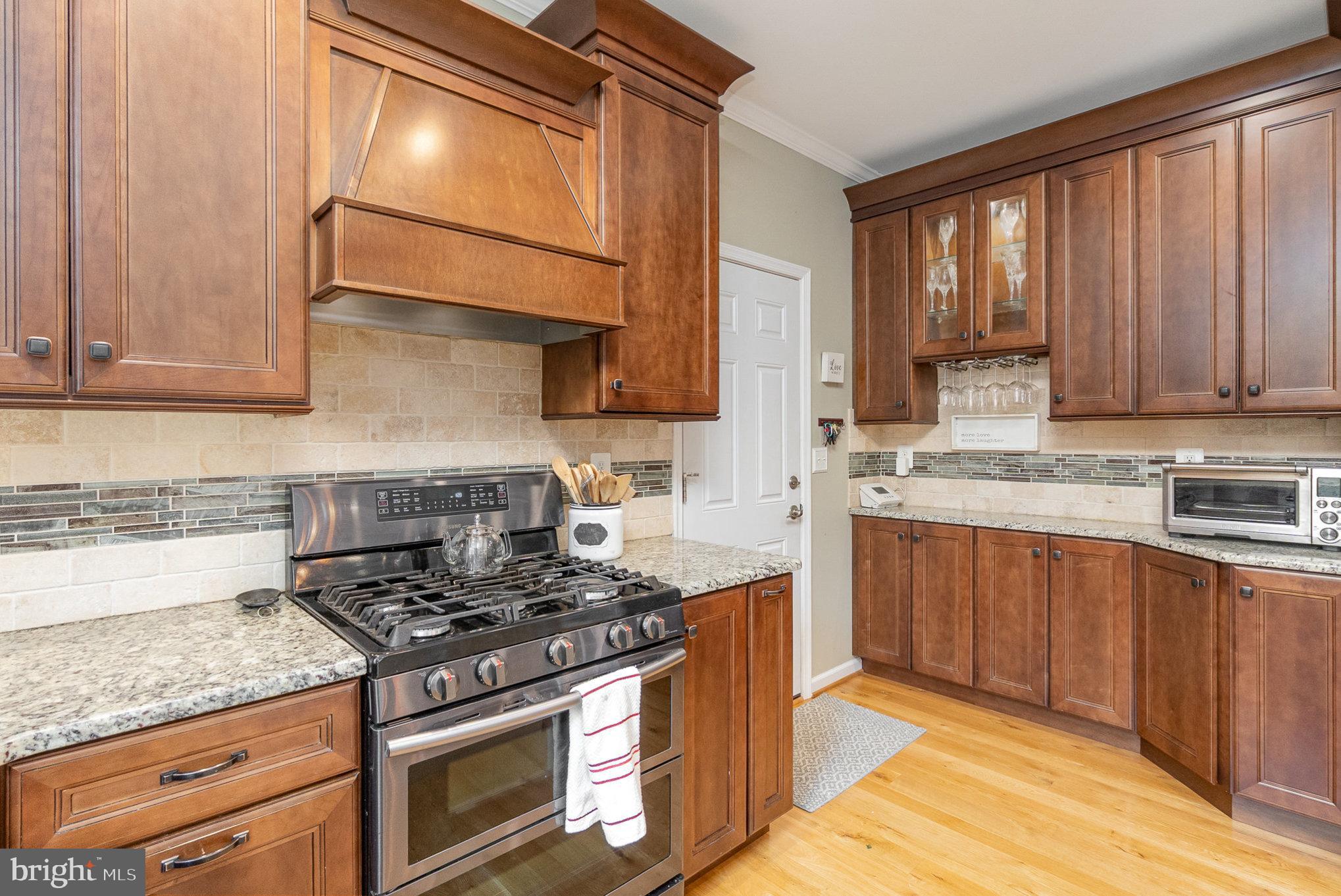 523 Copeland Road Fallston, MD 21047 - Photo 27 of 72 a kitchen with stainless steel appliances granite countertop wooden cabinets stove top oven and sink