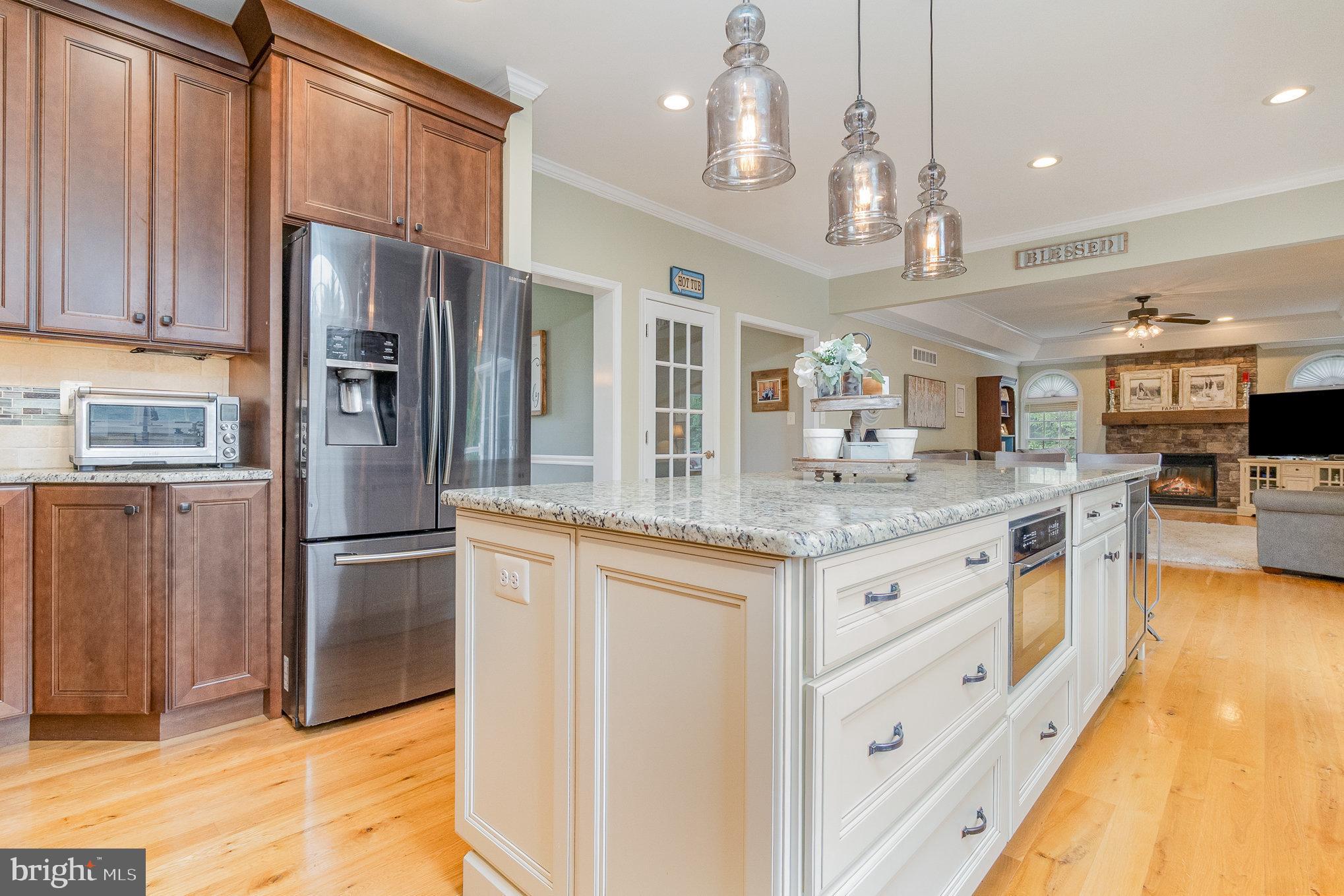 523 Copeland Road Fallston, MD 21047 - Photo 29 of 72 a kitchen with stainless steel appliances granite countertop a refrigerator a sink dishwasher a stove and a dining table with wooden floor