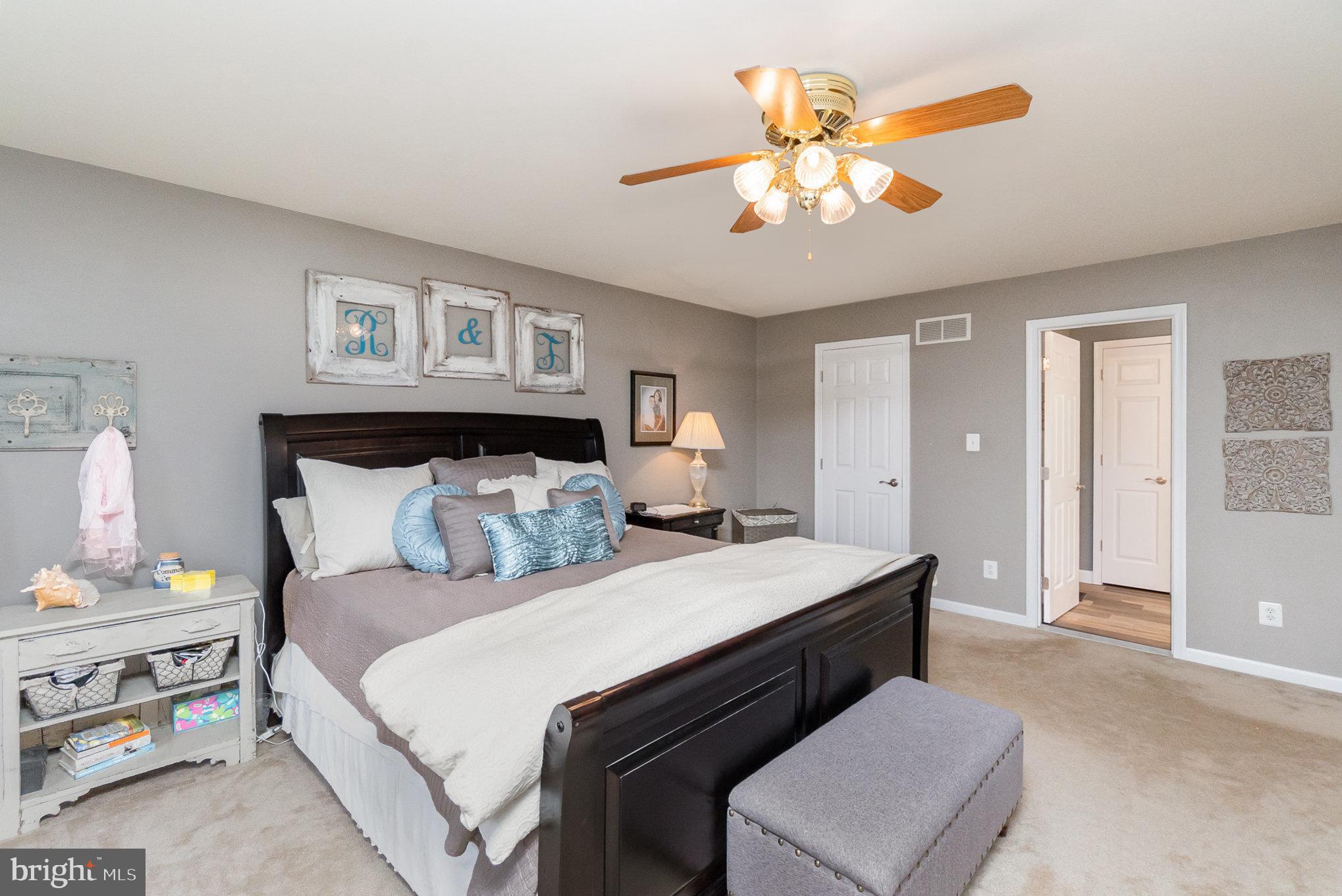 523 Copeland Road Fallston, MD 21047 - Photo 37 of 72 a bedroom with a bed and a chandelier