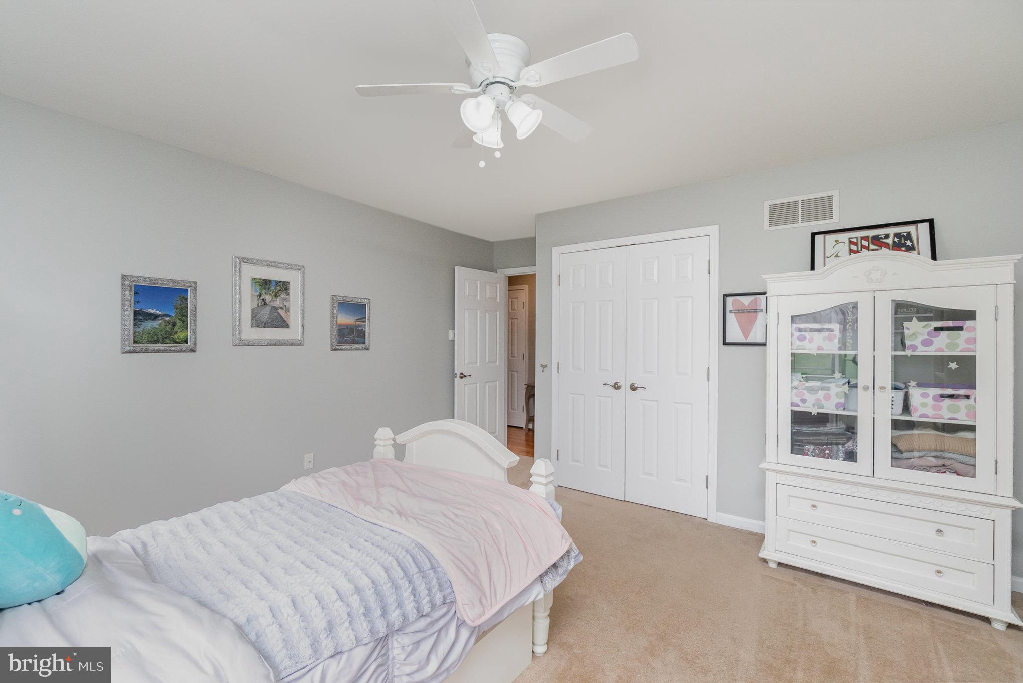 523 Copeland Road Fallston, MD 21047 - Photo 45 of 72 a bedroom with a large bed and a chandelier fan