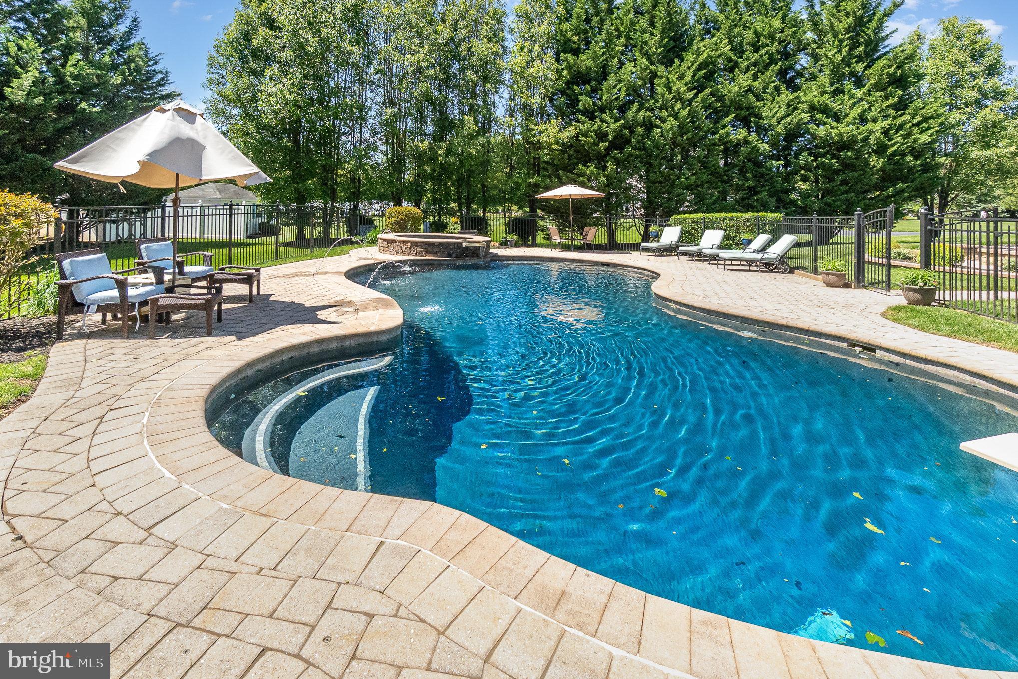 523 Copeland Road Fallston, MD 21047 - Photo 9 of 72 a view of a swimming pool with lawn chairs under an umbrella