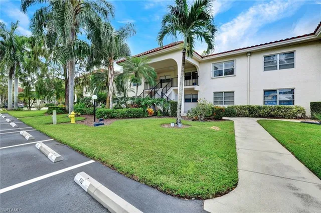 a view of a white house with a yard