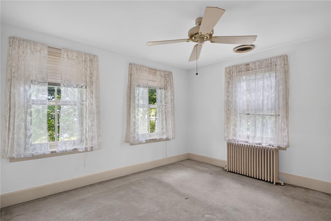 765 East Macada Road Bethlehem, PA 18017 - Photo 26 of 46 Well-lit room offers comfort with classic radiator heating and an overhead fan for air circulation.