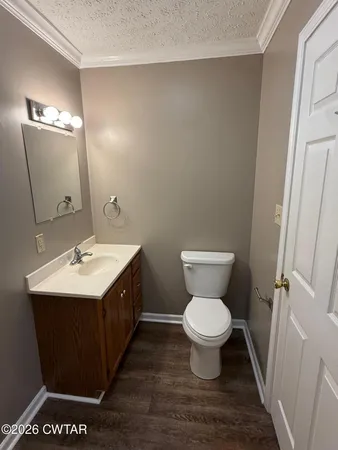 a bathroom with a double vanity sink toilet and a mirror