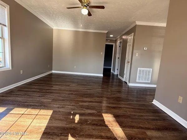 a view of a hallway with wooden floor