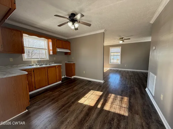 a view of kitchen with sink and wooden floor