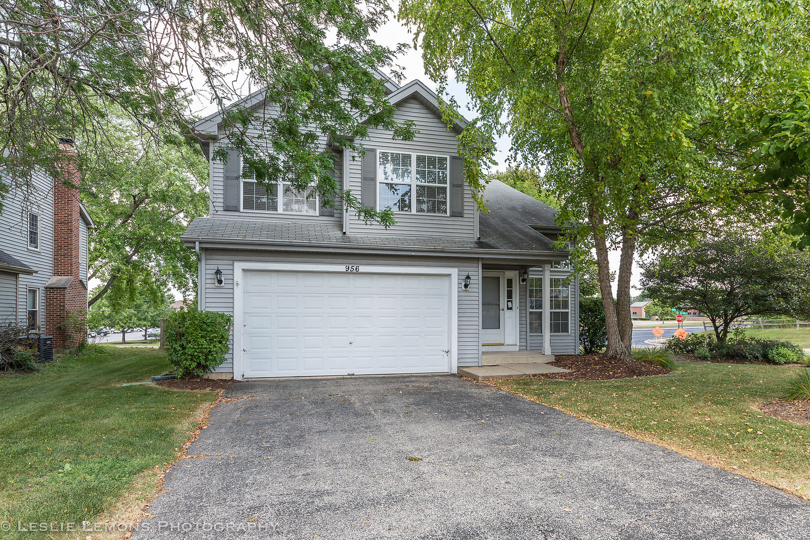 956 Pin Oak Circle Cary, IL 60013 - Photo 2 of 31 a front view of a house with a yard and garage