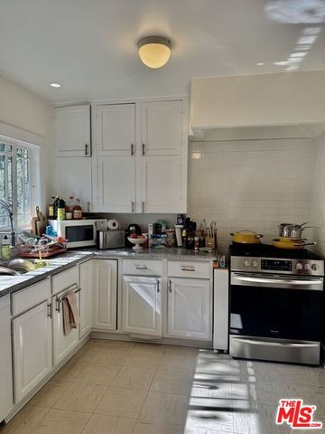 a kitchen with a stove and cabinets
