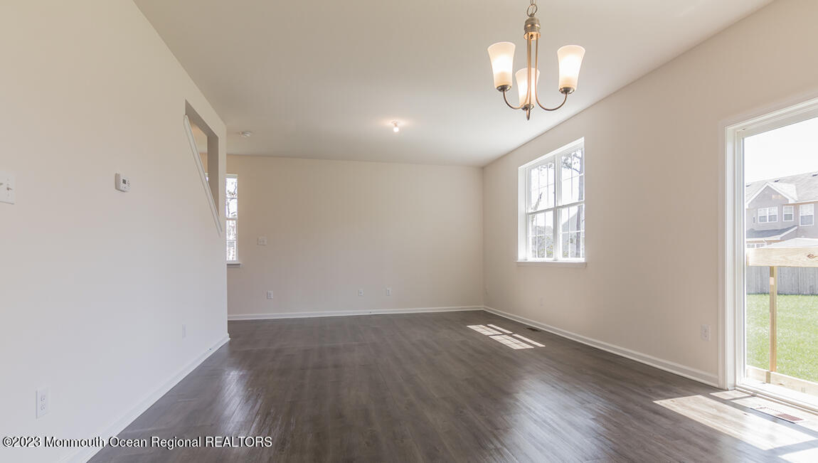 35 Phoebe Drive Barnegat, NJ 08005 - Photo 3 of 21 an empty room with wooden floor chandelier and windows