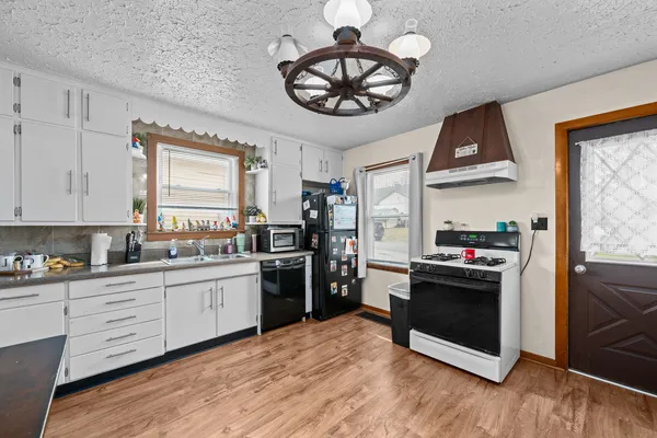 a kitchen with stainless steel appliances granite countertop a stove and a refrigerator