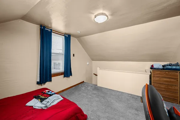 a bedroom with a bed and a mirror