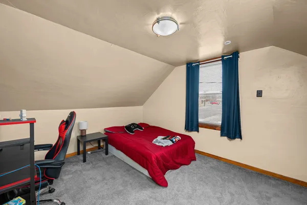 a bedroom with a bed and a large window