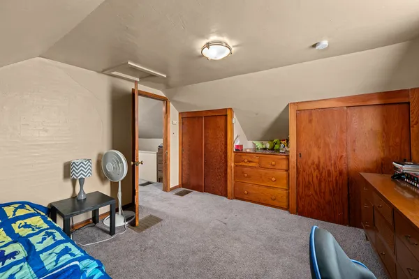 a bedroom with furniture and a window